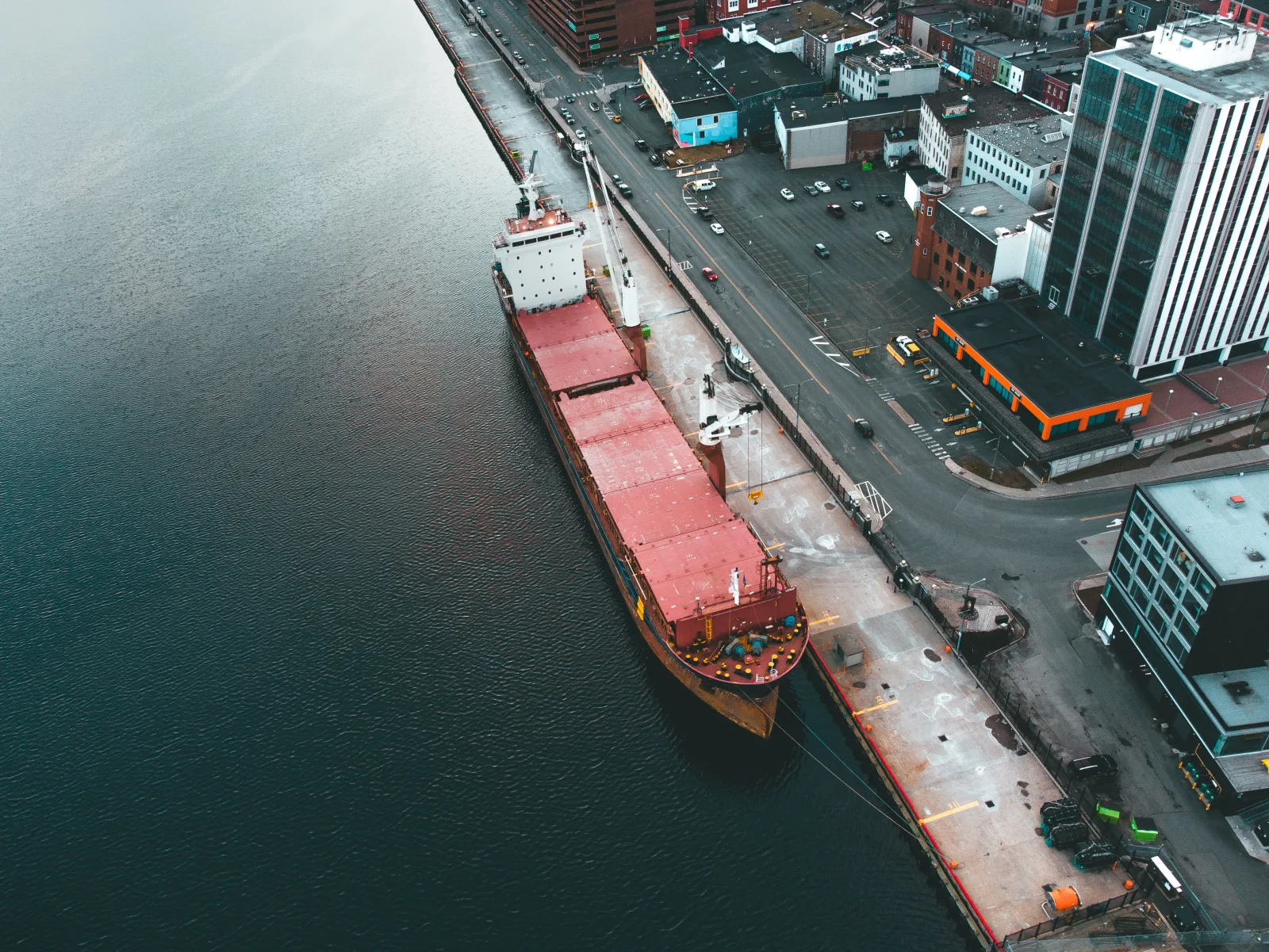 Aerial view of a docked cargo ship at an industrial port